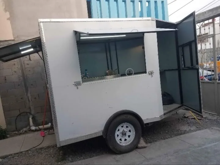 White food trailer, street side, serving window and rear door open